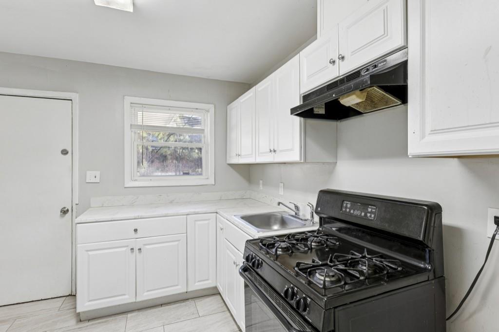 61 Pine Street Northeast Fairburn, GA 30213 - Photo 10 of 22 a kitchen with white cabinets and appliances