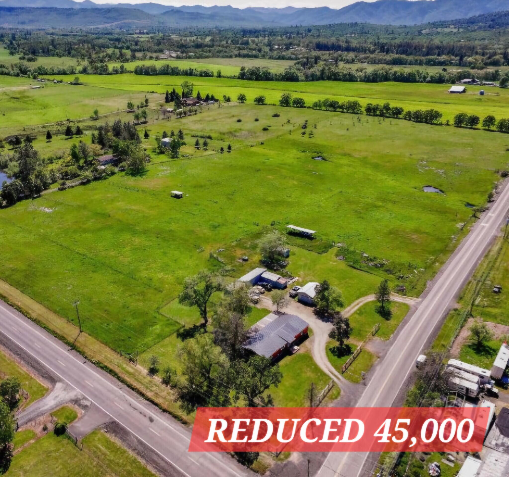 5225 Dodge Road White City, OR 97503 - Photo 2 of 49 a view of a lush green hillside and houses