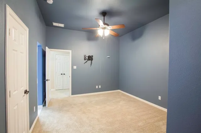 an empty room with windows and closet