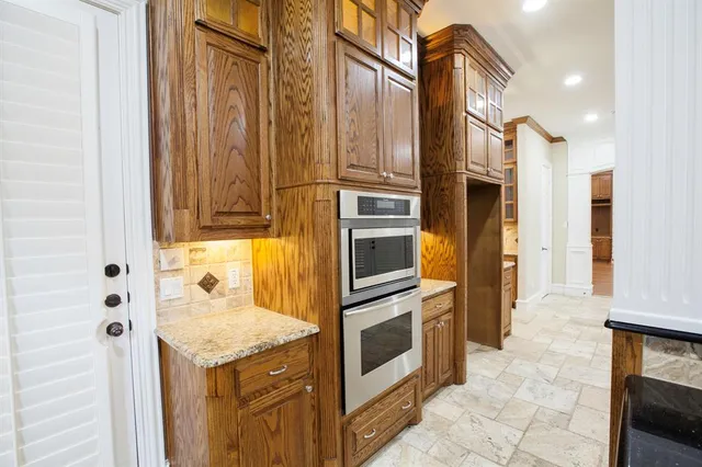 a stove top oven sitting inside of a kitchen