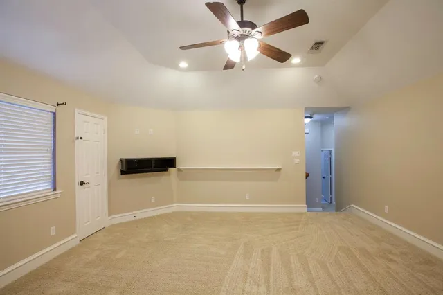 an empty room with closet and windows