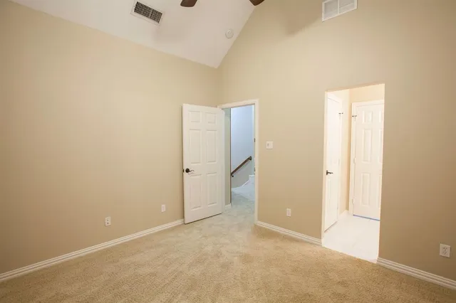 an empty room with closet and windows