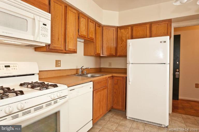 17 Hamill Road, Unit A Baltimore, MD 21210 - Photo 5 of 21 a kitchen with a refrigerator and a stove