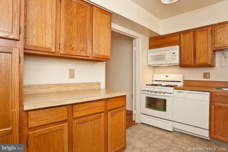 17 Hamill Road, Unit A Baltimore, MD 21210 - Photo 6 of 21 a kitchen with stainless steel appliances granite countertop a stove a sink and a microwave