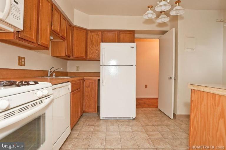 17 Hamill Road, Unit A Baltimore, MD 21210 - Photo 8 of 21 a kitchen with a refrigerator sink stove and cabinets
