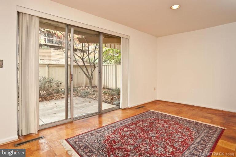 17 Hamill Road, Unit A Baltimore, MD 21210 - Photo 9 of 21 a view of an empty room with wooden floor and a window