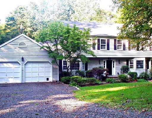 14 Horseshoe Ridge Road Newtown, CT 06482 - Photo 1 of 1 a front view of a house with a garden and plants