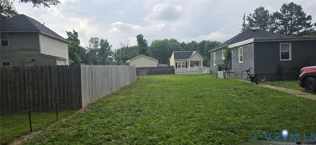 a view of a house with a yard and sitting area