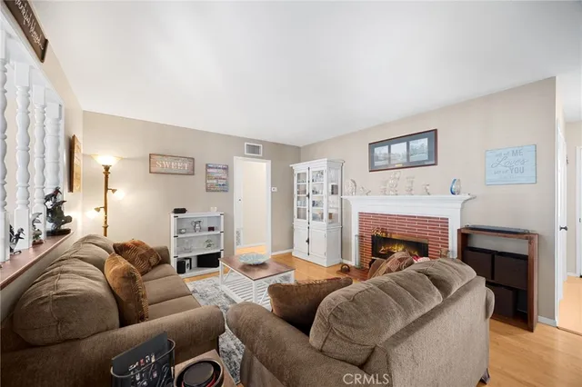 a living room with furniture a fireplace and a large window