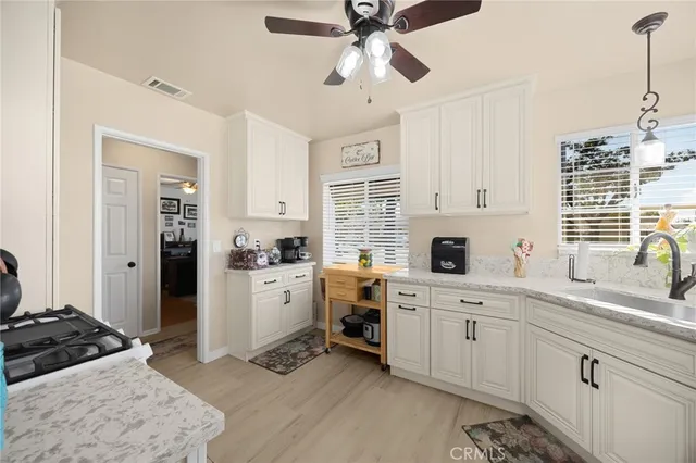a kitchen with a stove a sink and a refrigerator