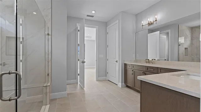 a bathroom with a granite countertop sink mirror and double
