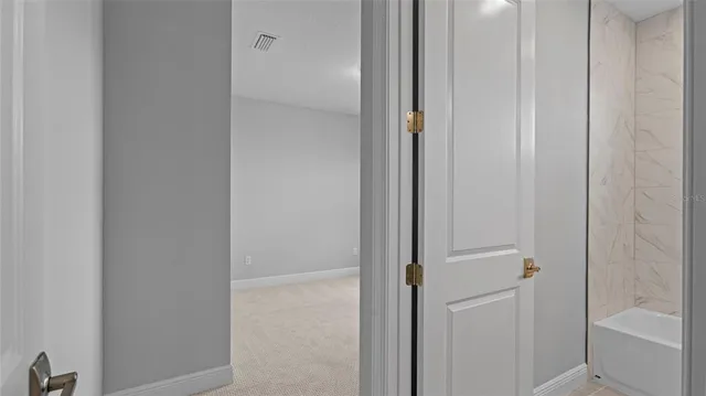 a view of a bathroom from the hallway