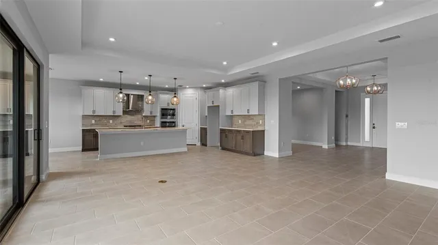 a view of kitchen with refrigerator sink and cabinets
