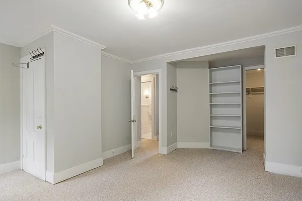 a view of an empty room with a closet