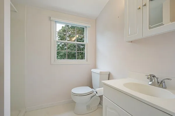 a white toilet sitting next to a bathroom sink
