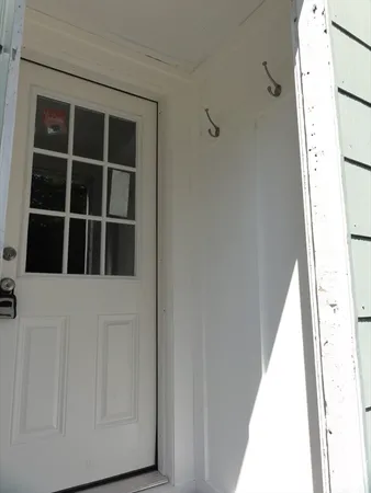 a view of closet with wooden floor