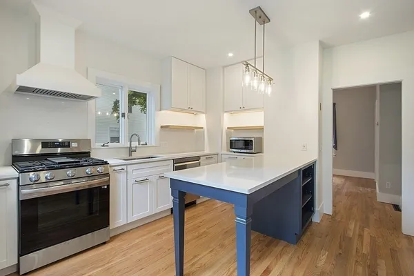 a kitchen with a stove a sink and a refrigerator