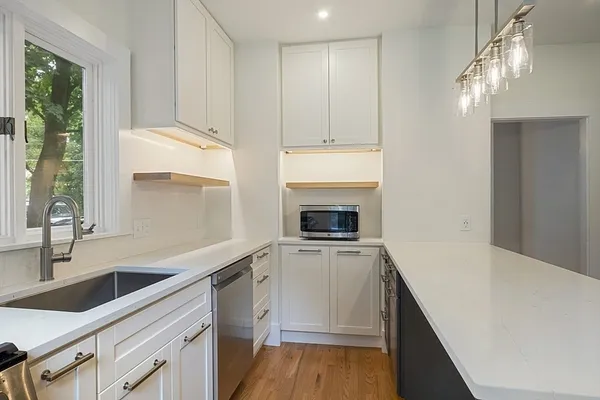 a kitchen with a sink stove and cabinets
