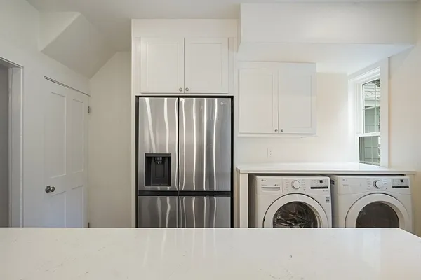 a view of a hallway with washer and dryer