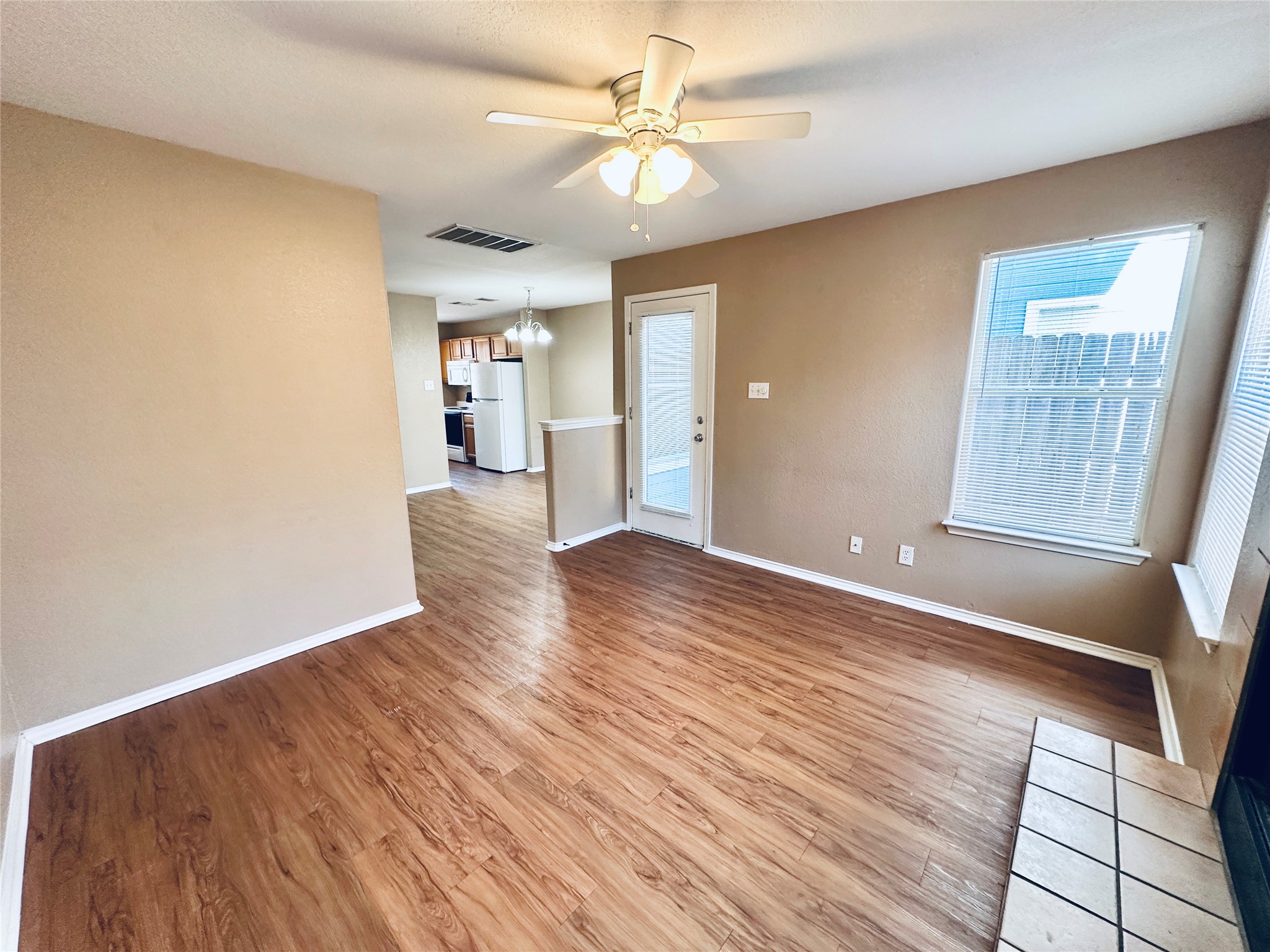 8814 Schick Road, Unit B Austin, TX 78729 - Photo 14 of 36 Unfurnished living room with ceiling fan, light wood-type flooring, and suspended lighting