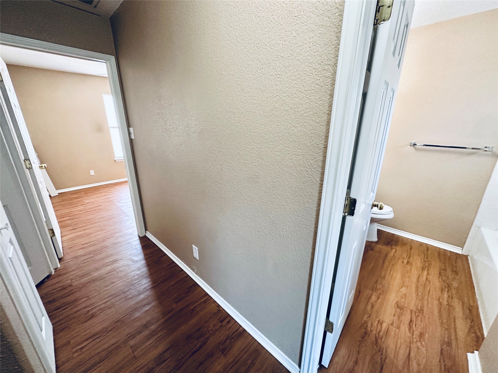 8814 Schick Road, Unit B Austin, TX 78729 - Photo 21 of 36 Corridor featuring dark wood-style flooring and a textured wall