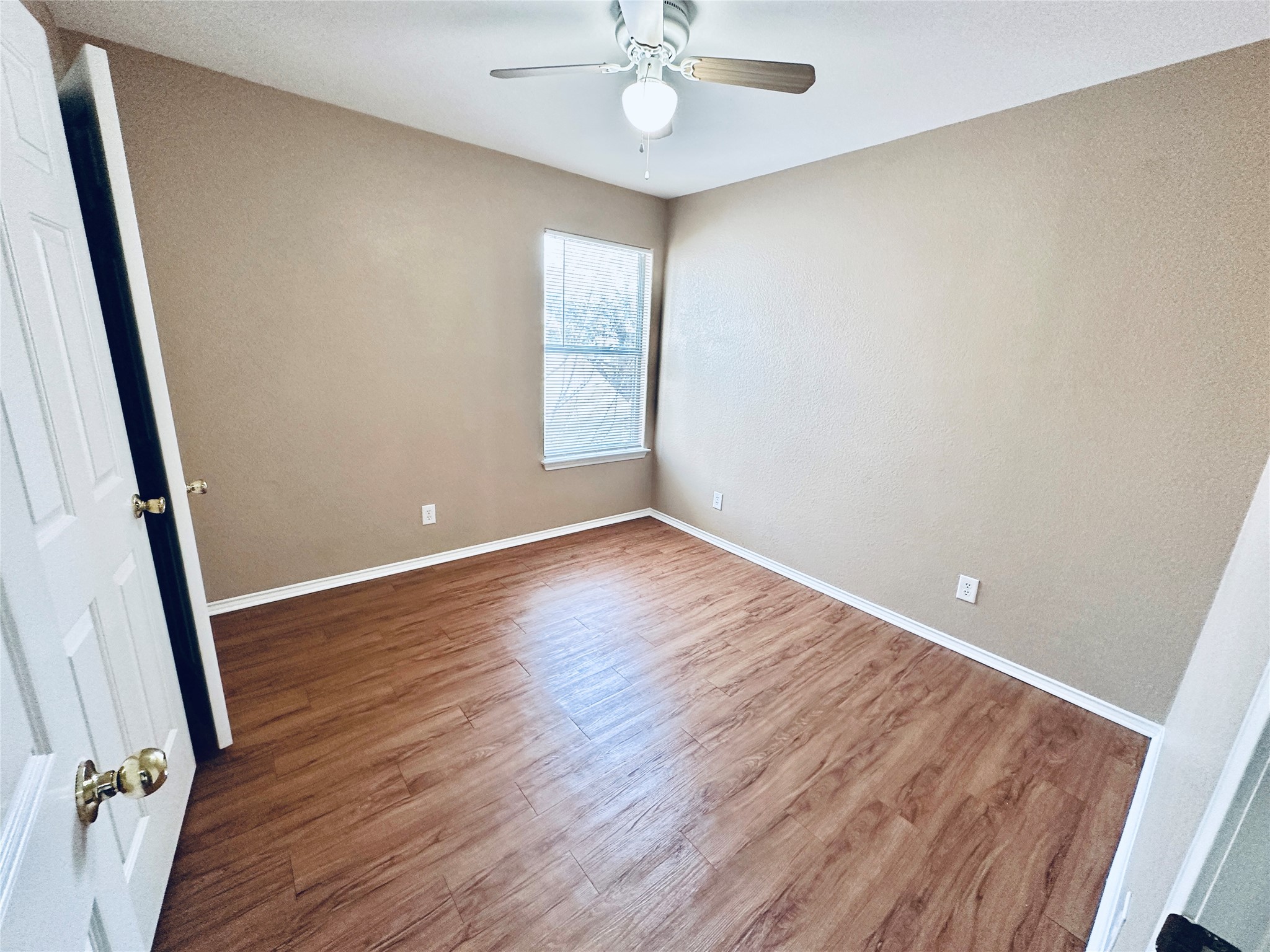8814 Schick Road, Unit B Austin, TX 78729 - Photo 23 of 36 Empty room featuring wood finished floors and a ceiling fan