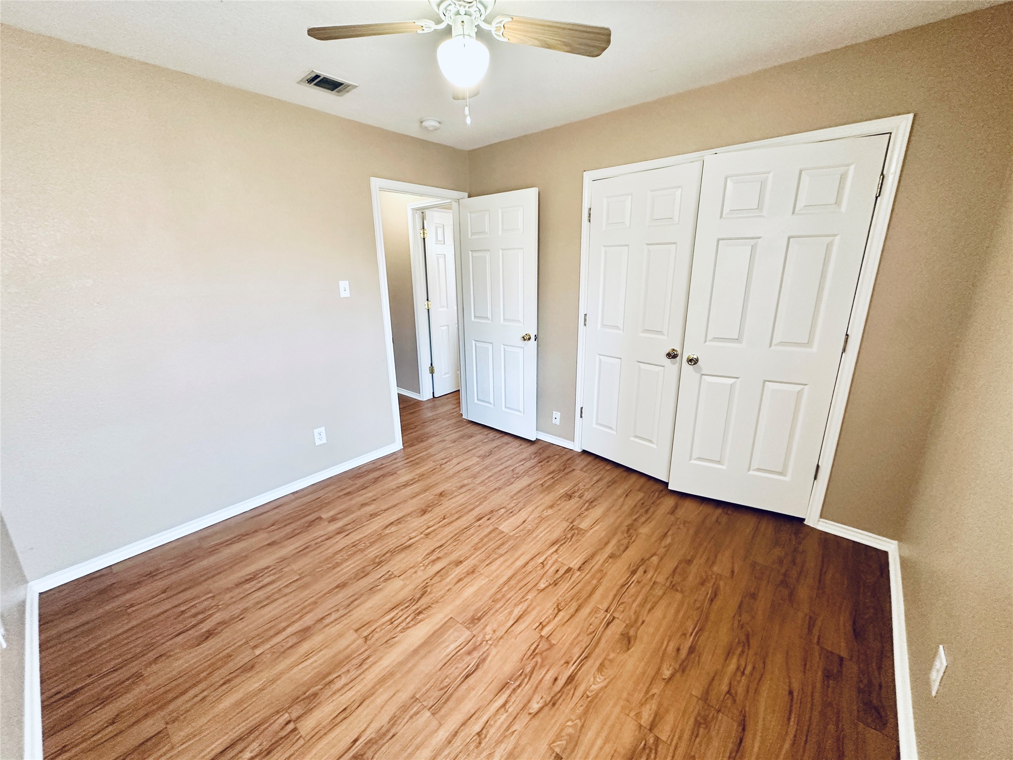 8814 Schick Road, Unit B Austin, TX 78729 - Photo 24 of 36 Unfurnished bedroom featuring light wood finished floors, ceiling fan, and a closet