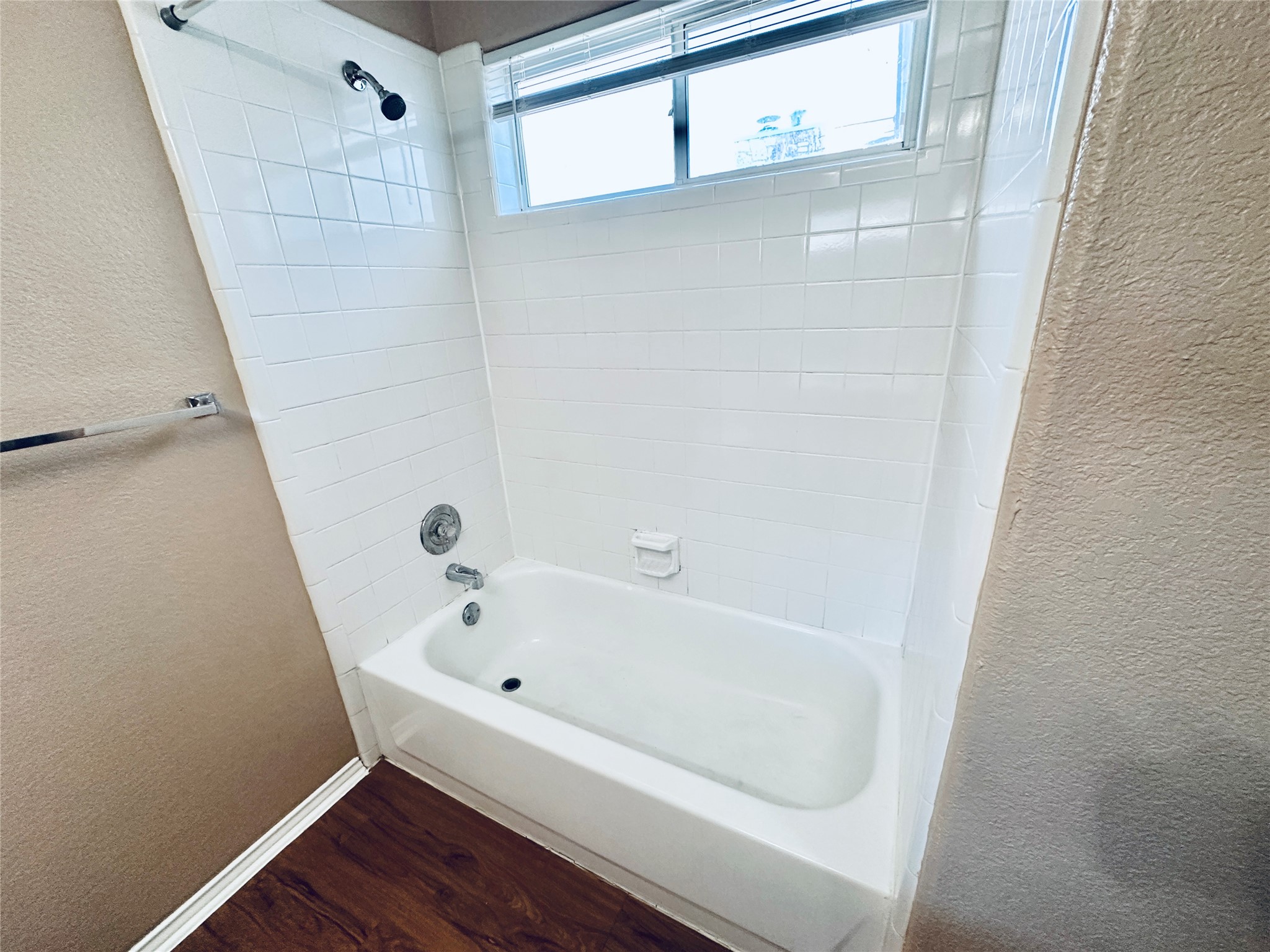 8814 Schick Road, Unit B Austin, TX 78729 - Photo 27 of 36 Full bath featuring a textured wall, shower / washtub combination, and dark wood-type flooring