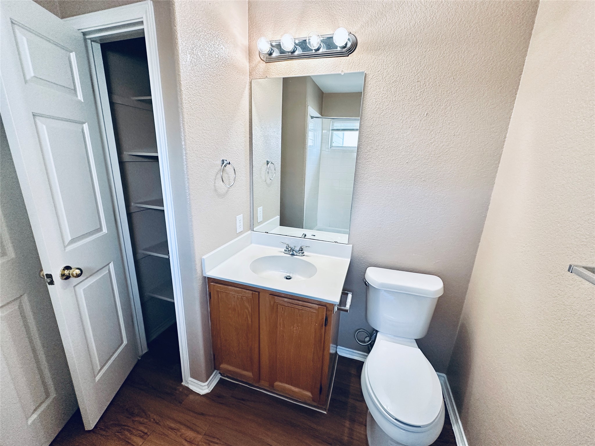 8814 Schick Road, Unit B Austin, TX 78729 - Photo 28 of 36 Bathroom featuring vanity, dark wood-type flooring, and a textured wall