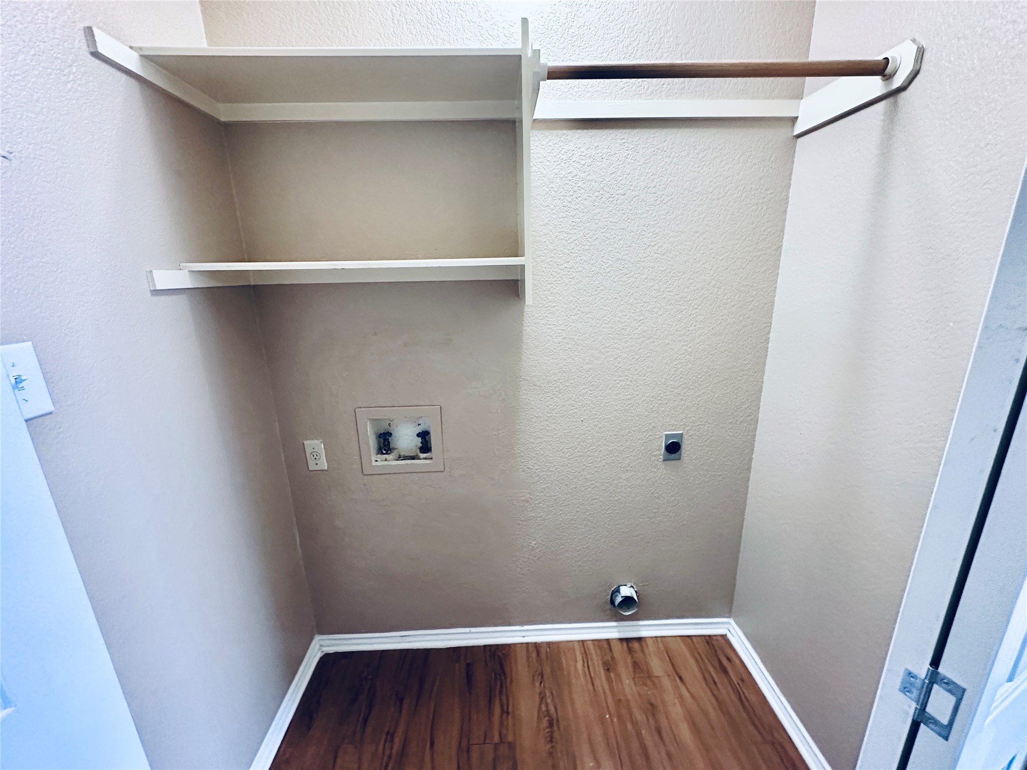 8814 Schick Road, Unit B Austin, TX 78729 - Photo 29 of 36 Laundry area featuring a textured wall, dark wood finished floors, washer hookup, and electric dryer hookup
