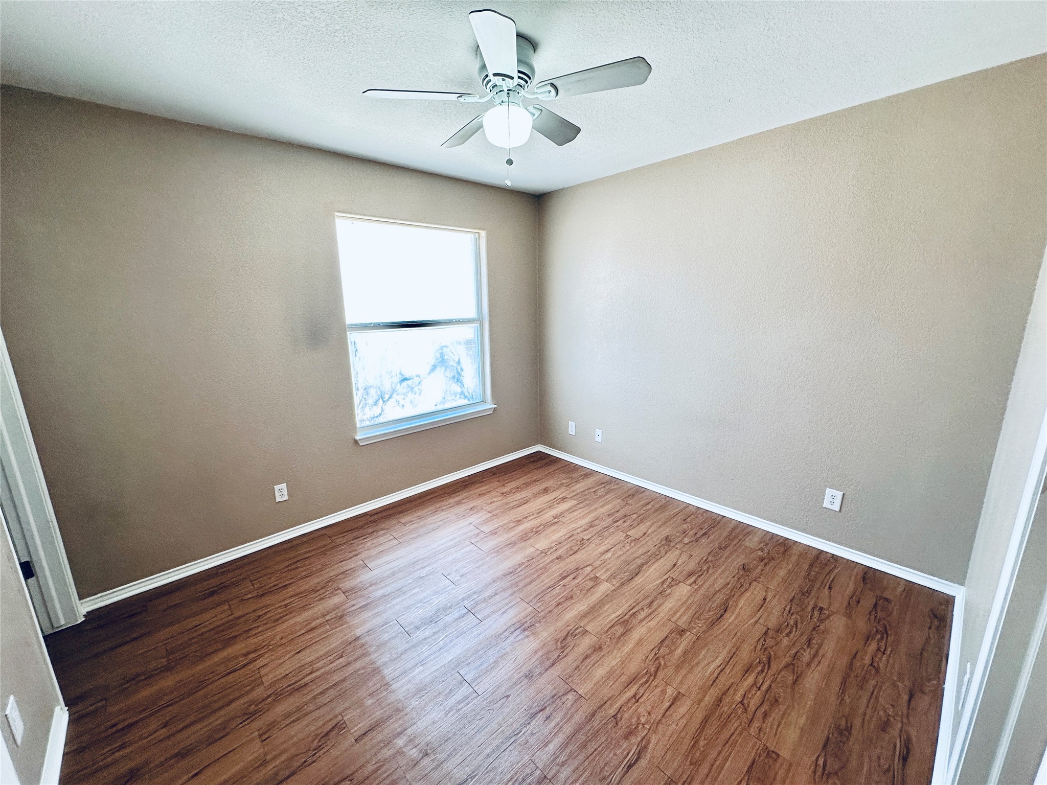 8814 Schick Road, Unit B Austin, TX 78729 - Photo 30 of 36 Empty room featuring dark wood-style floors, ceiling fan, and a textured ceiling