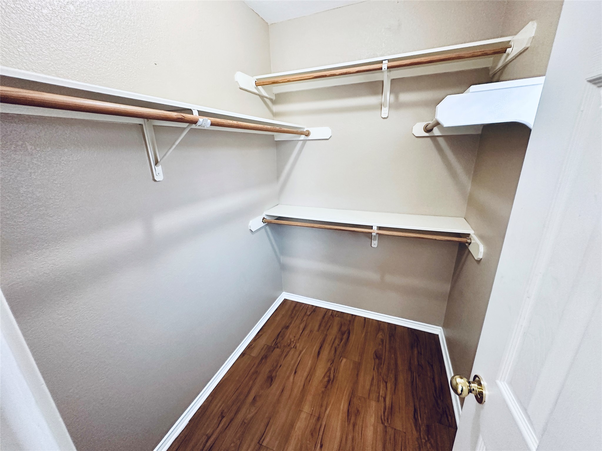 8814 Schick Road, Unit B Austin, TX 78729 - Photo 33 of 36 Walk in closet with dark wood finished floors