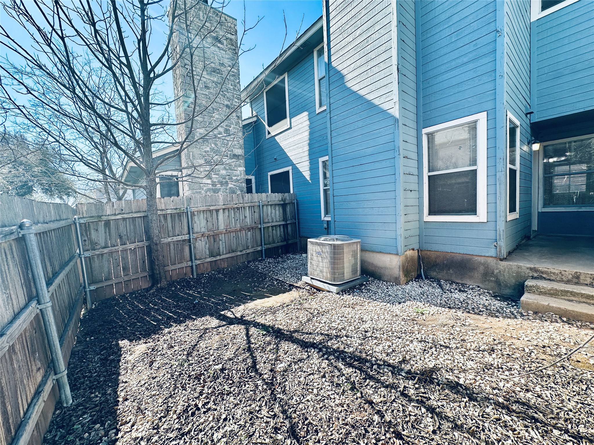 8814 Schick Road, Unit B Austin, TX 78729 - Photo 35 of 36 View of side of home featuring a fenced backyard and a chimney