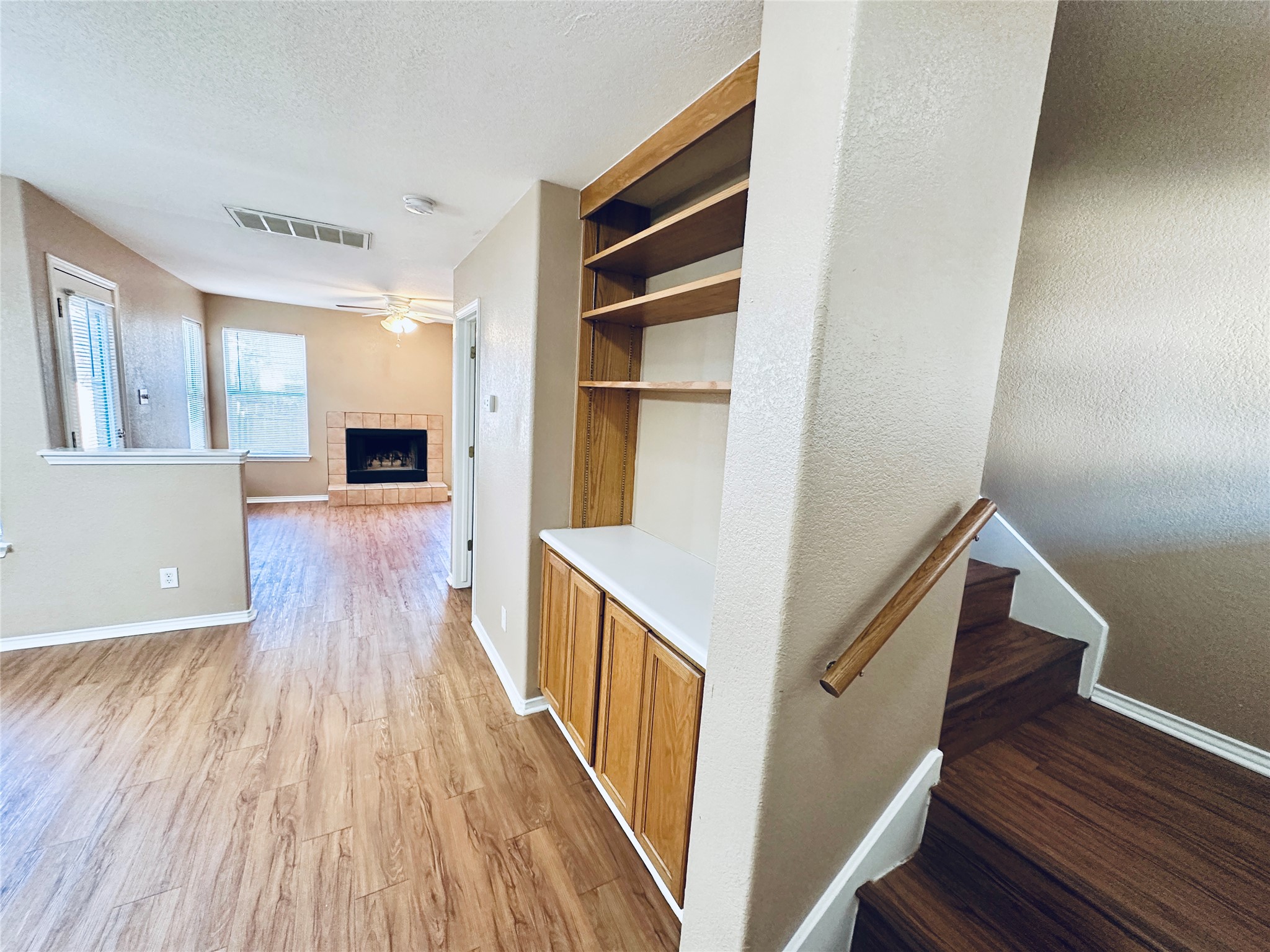 8814 Schick Road, Unit B Austin, TX 78729 - Photo 5 of 36 Hall featuring light wood-type flooring, a textured ceiling, and built in features