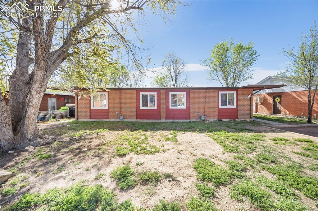 357-359 Fairway South Colorado Springs, CO 80906 - Photo 1 of 20 a view of a brick house with a yard