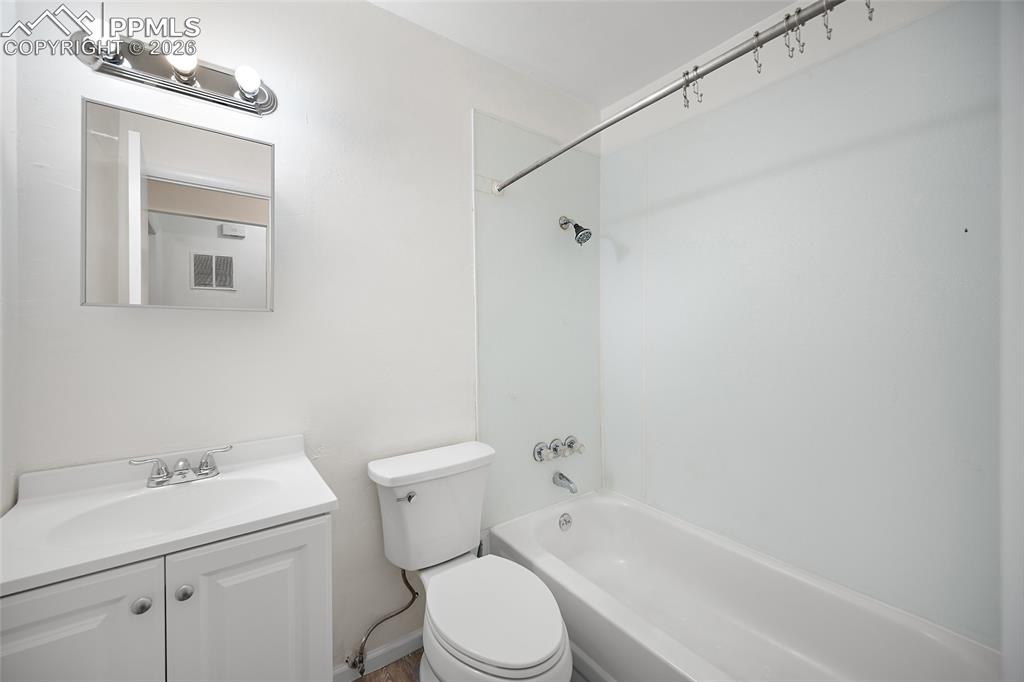 357-359 Fairway South Colorado Springs, CO 80906 - Photo 13 of 20 a white toilet sitting next to a bathroom sink