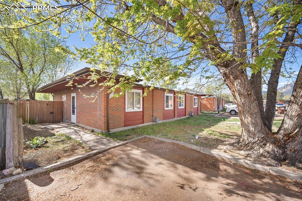 357-359 Fairway South Colorado Springs, CO 80906 - Photo 4 of 20 a view of a yard in front of a house with large tree