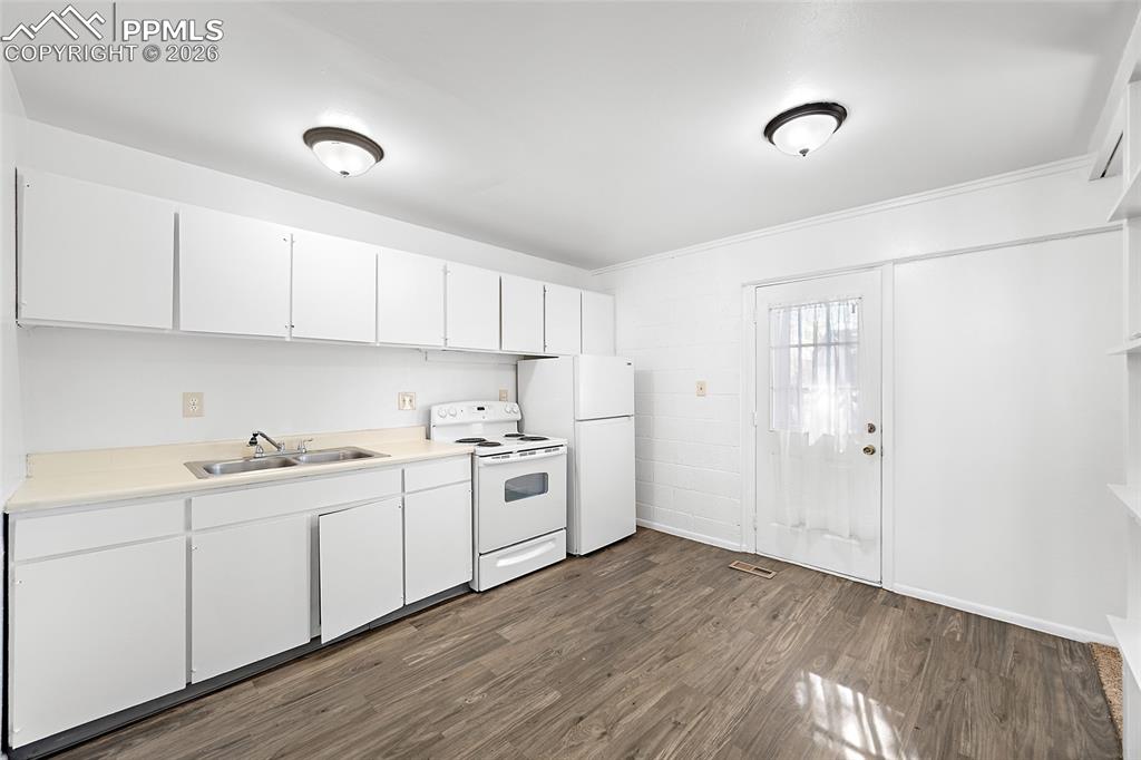 357-359 Fairway South Colorado Springs, CO 80906 - Photo 5 of 20 a kitchen with white cabinets and white appliances