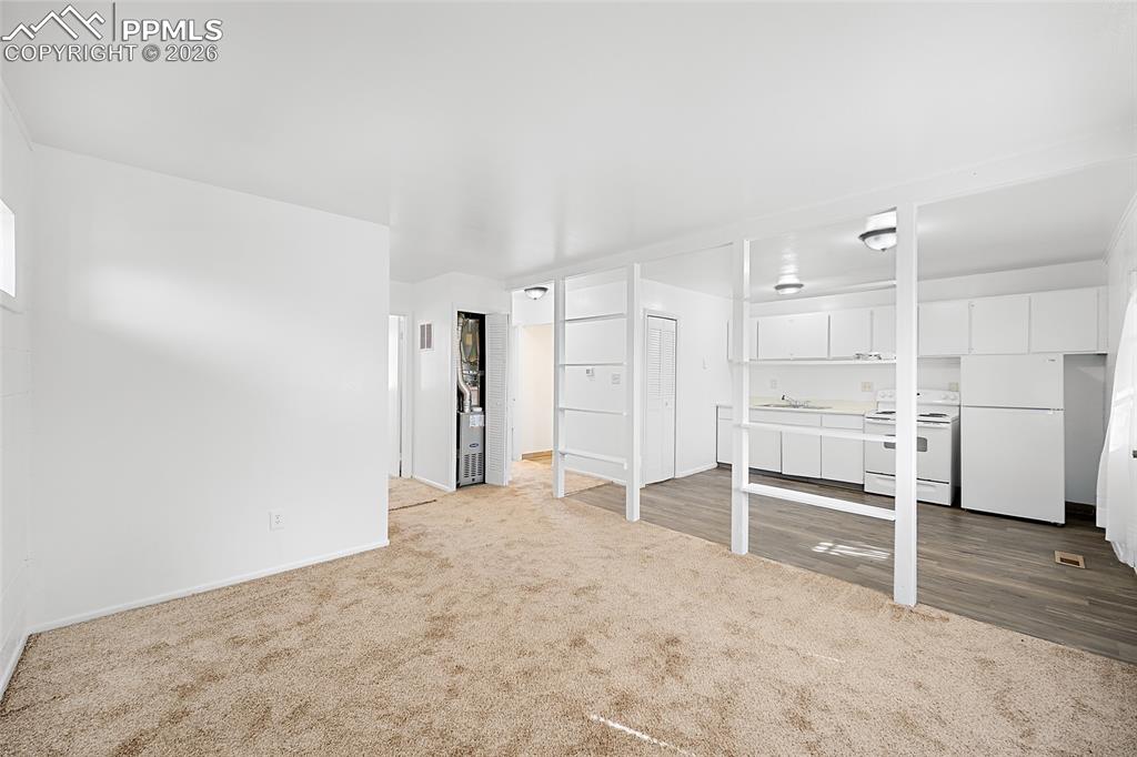 357-359 Fairway South Colorado Springs, CO 80906 - Photo 6 of 20 a view of an empty room with a kitchen