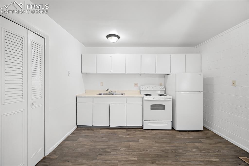357-359 Fairway South Colorado Springs, CO 80906 - Photo 7 of 20 a kitchen with white cabinets and white appliances