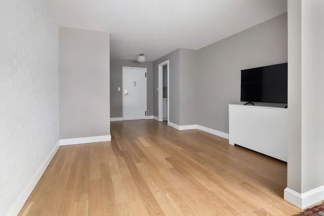 a view of room with wooden floor and rug