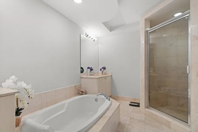 a bathroom with a tub sink and mirror