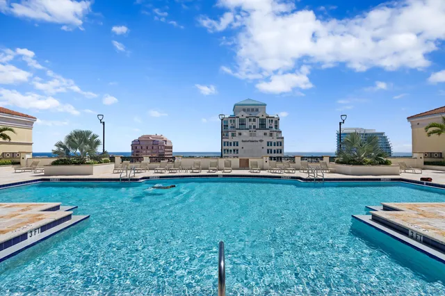 a view of a swimming pool and lounge chairs