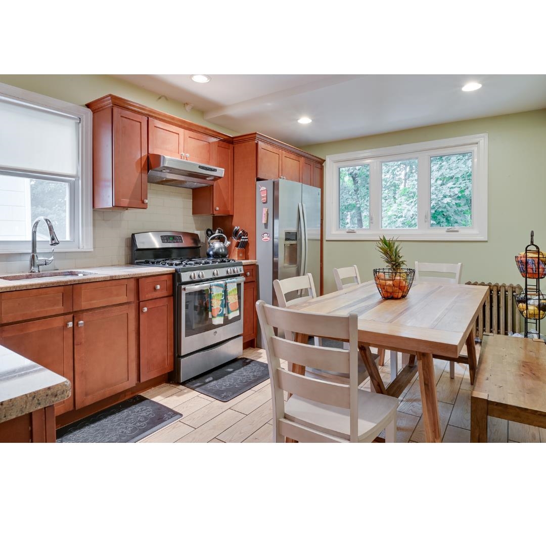 45 Ridgehurst Road West Orange, NJ 07052 - Photo 4 of 10 a kitchen with stainless steel appliances granite countertop a stove a sink dishwasher and cabinets with wooden floor