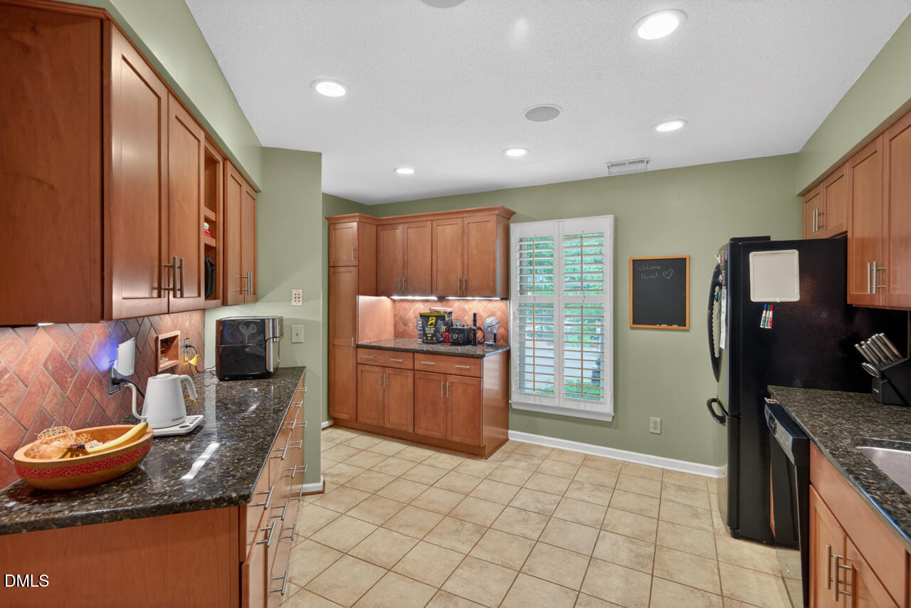 3307 Coachman's Way Durham, NC 27705 - Photo 6 of 50 a kitchen with granite countertop cabinets and refrigerator