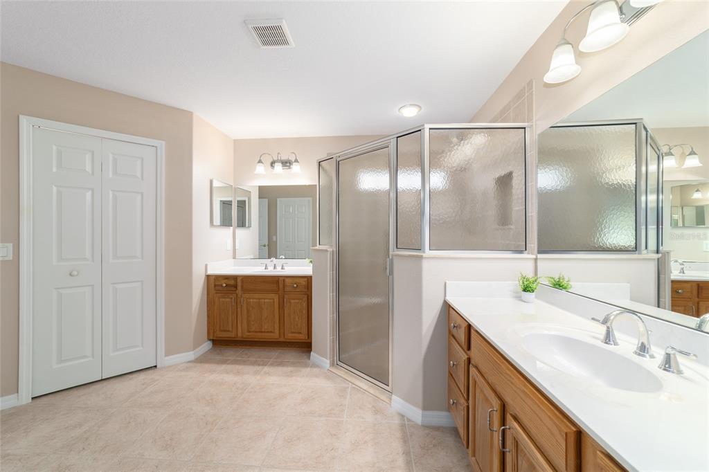 16369 Southwest 14th Avenue Road Ocala, FL 34473 - Photo 29 of 49 a bathroom with a double vanity sink mirror and shower