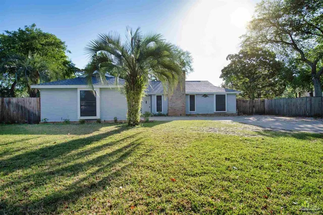 a front view of house with yard and trees