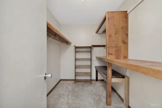 a view of an empty room with a staircase