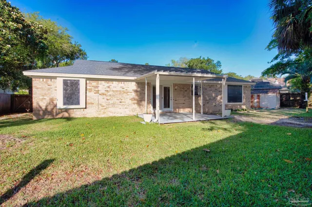 a front view of house with yard and outdoor seating