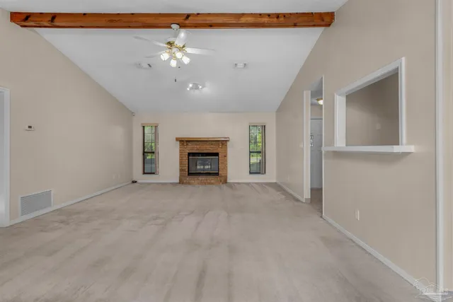 a view of an empty room with a fireplace